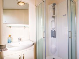 A bathroom with a sink and shower at 91 Swanage Coastal Park, Swanage