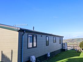 A mobile home with windows and an antenna in an outdoor area at 91 Swanage Coastal Park in Swanage