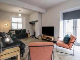 A living room with a sofa and armchair at Green Bank in Betws-Y-Coed