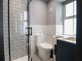 A bathroom with a shower, toilet, and sink at Green Bank in Betws-Y-Coed