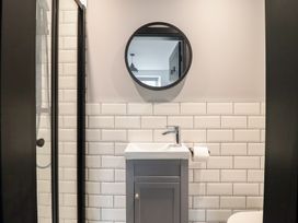 A bathroom with a sink and mirror at Green Bank in Betws-Y-Coed