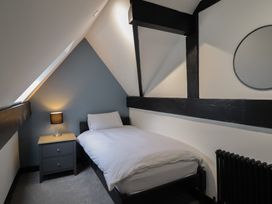 A bedroom with a bed and nightstand at Green Bank in Betws-Y-Coed