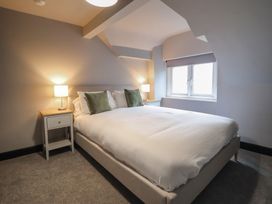 A bedroom with a bed and bedside table at Green Bank in Betws-Y-Coed
