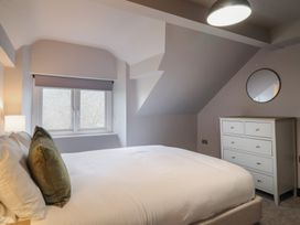 A bedroom with a bed and dresser at Green Bank in Betws-Y-Coed
