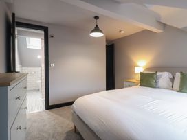 A bedroom with a bed and adjacent bathroom at Green Bank in Betws-Y-Coed