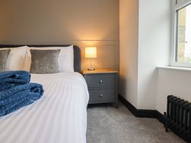 A bedroom with a bed and nightstand at Green Bank in Betws-Y-Coed
