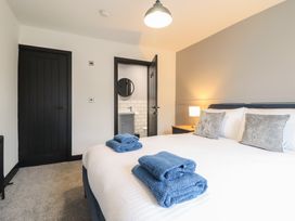A bedroom featuring a bed with towels on it at Green Bank in Betws-Y-Coed