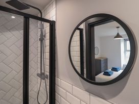 A bathroom with a shower and a mirror at Green Bank in Betws-Y-Coed