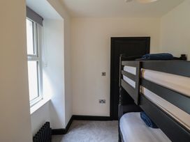 A bedroom with a bunk bed and a window at Green Bank in Betws-Y-Coed