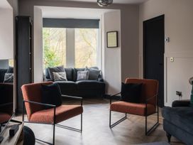 A living room with a sofa and chairs at Green Bank in Betws-Y-Coed