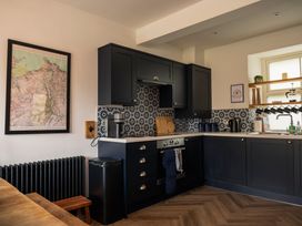 A kitchen with cabinets and appliances at Green Bank in Betws-Y-Coed