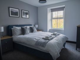 A bedroom with a bed and window at Green Bank in Betws-Y-Coed