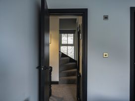 A hallway with stairs and a window at Green Bank in Betws-Y-Coed