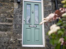 A door with a knocker and mail slot at Green Bank in Betws-Y-Coed