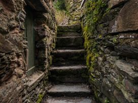 An outdoor staircase leading up through stone walls at Green Bank in Betws-Y-Coed