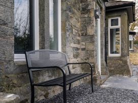 A bench beside a wall with windows at Green Bank in Betws-Y-Coed