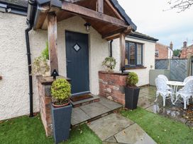 A garden entrance with steps and seating area at Cobble Cottage Long Marton near Appleby-In-Westmorland