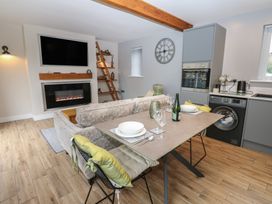 A living room with a sofa and dining table at Cobble Cottage Long Marton near Appleby-In-Westmorland