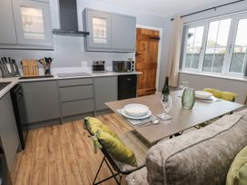 A kitchen with a table and chairs at Cobble Cottage in Long Marton near Appleby-In-Westmorland