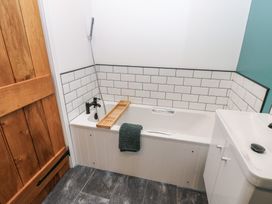 A bathroom with a bathtub and sink at Cobble Cottage Long Marton near Appleby-In-Westmorland