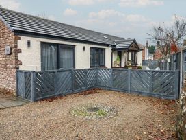 An exterior view of a house with a fenced garden at Cobble Cottage in Long Marton near Appleby-In-Westmorland