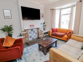 A living room with a tv and sofa at Captain Jacks in Whitby