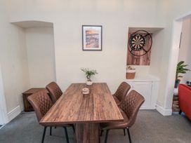 A dining room with a table and chairs at Captain Jacks in Whitby