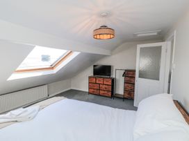 A bedroom with a bed and television at Captain Jacks in Whitby