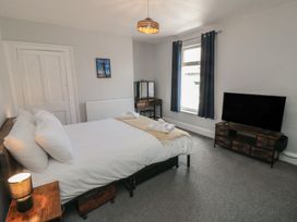 A bedroom with a bed and television at Captain Jacks in Whitby