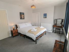 A bedroom with a bed and nightstand at Captain Jacks in Whitby