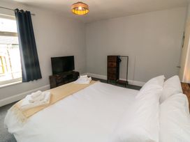 A bedroom with a bed and television at Captain Jacks in Whitby