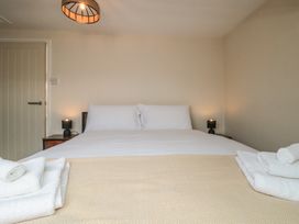 A bedroom with a bed and nightstands at Captain Jacks in Whitby