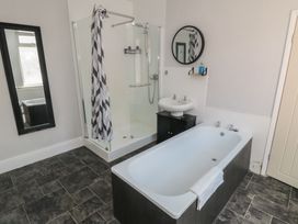 A bathroom with a shower and bathtub at Captain Jacks in Whitby