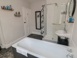A bathroom with a bathtub and shower at Captain Jacks in Whitby