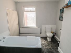 A bathroom with a bathtub and toilet at Captain Jacks in Whitby