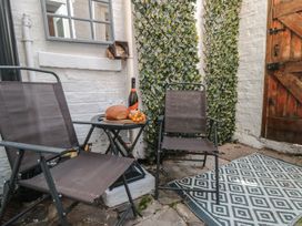 An outdoor seating area with chairs and a table at Captain Jacks in Whitby