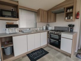 A kitchen with appliances and storage at MC15 Rhyl