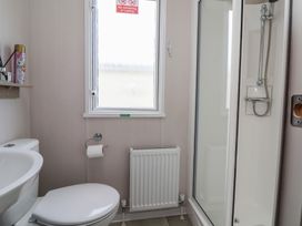 A bathroom with a shower and toilet at MC15 in Rhyl