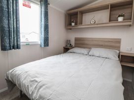 A bedroom with a bed and window at MC15 Rhyl