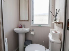A bathroom with sink and toilet at MC15 in Rhyl
