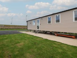 A mobile home with stairs and windows at MC15 in Rhyl