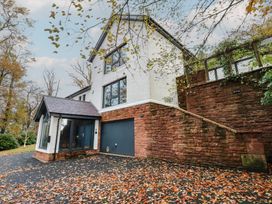 A house with a garage and steps at Chapel Hill in Catlowdy