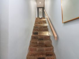 A staircase with stone steps and light fixtures at Chapel Hill in Catlowdy