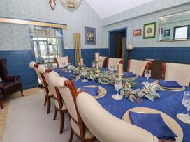A dining room with a table set for dinner at Chapel Hill in Catlowdy