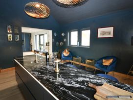 A kitchen with a large island and wine bottle at Chapel Hill in Catlowdy