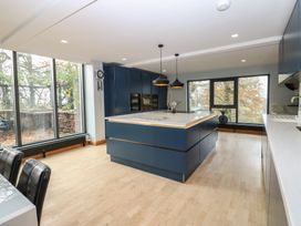 A kitchen with a central island and large windows at Chapel Hill in Catlowdy