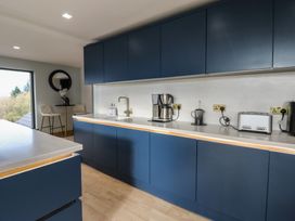 A kitchen with blue cabinets and appliances at Chapel Hill in Catlowdy