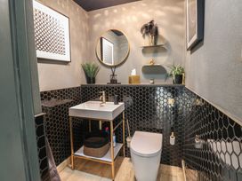 A bathroom with a sink and toilet at Chapel Hill in Catlowdy