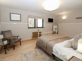 A bedroom with a bed and chair at Chapel Hill in Catlowdy