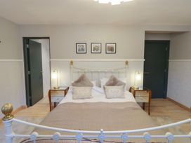 A bedroom with a bed and bedside tables at Chapel Hill in Catlowdy